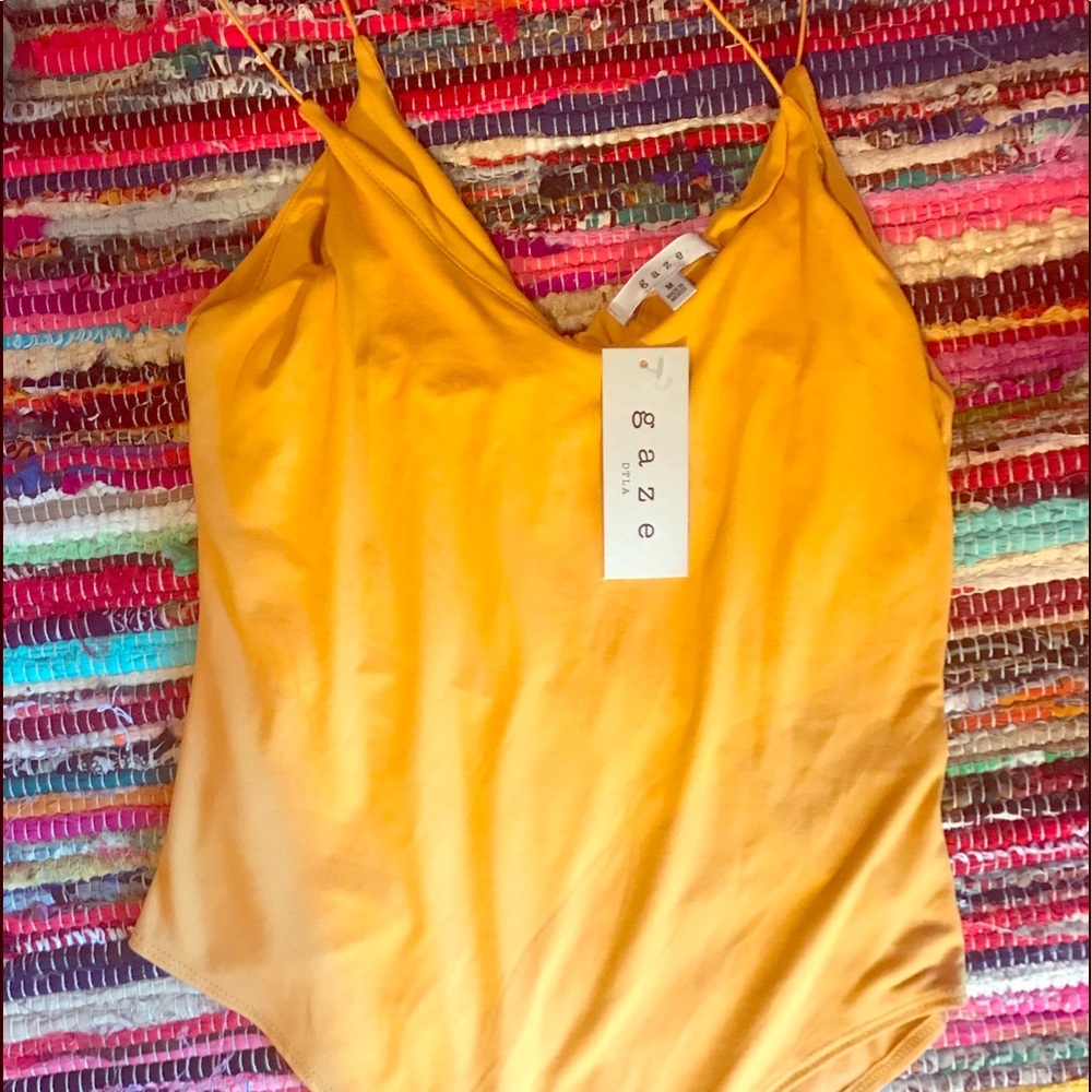 yellow medium body suit with tags still on